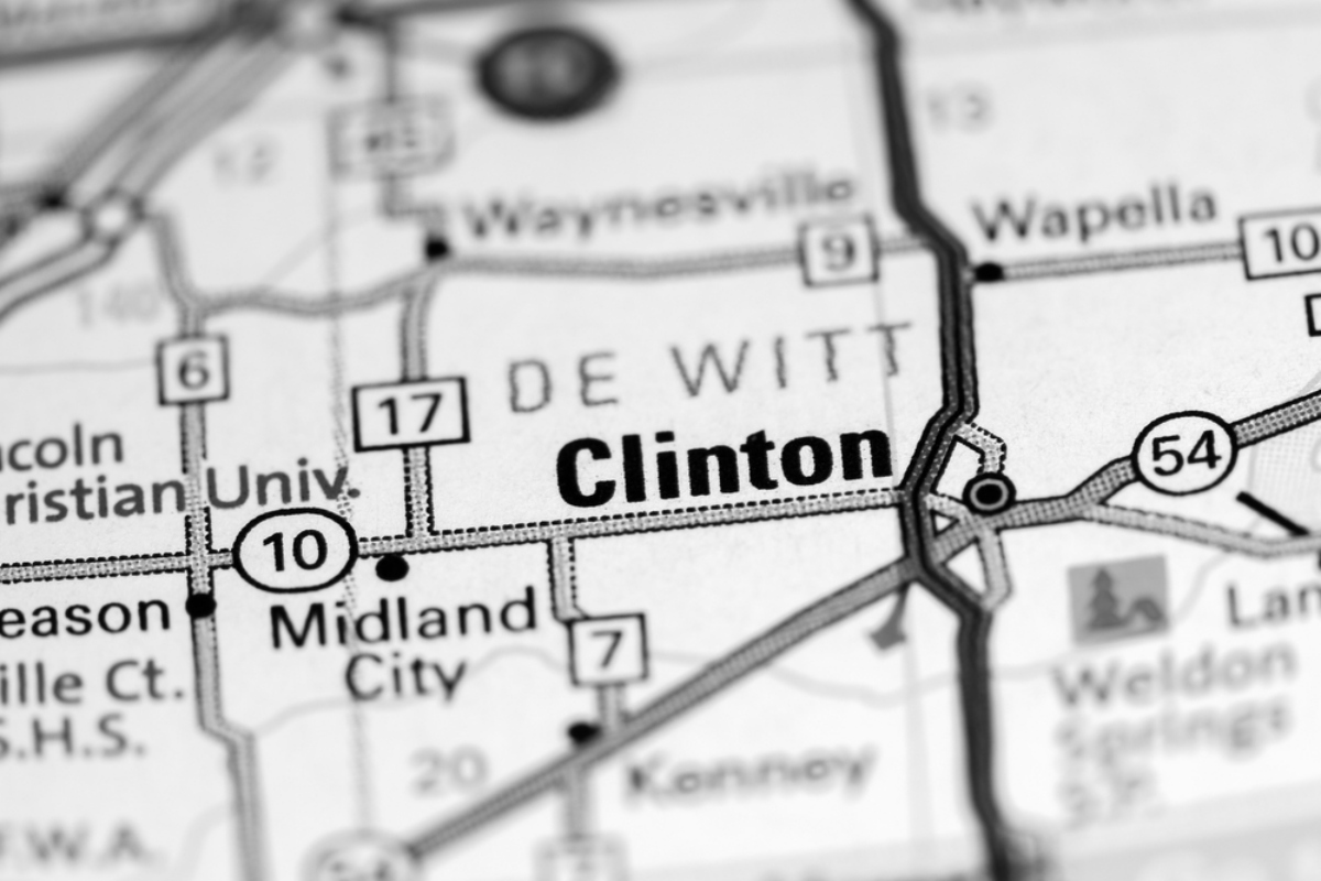 Close-up map showing Clinton with nearby towns and highways (Interstate 10, 54, 17) in a black-and-white route layout
