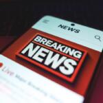 Smartphone screen showing a bold 'BREAKING NEWS' banner in a news app.