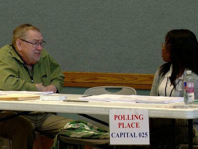 Election judges John Brim and Josephine Oke help run the 2026 primary election in Sangamon County. (Capitol News Illinois photo by Andrew Campbell)