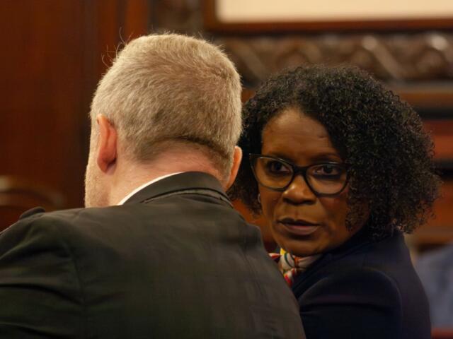 State Sen. Adriene Johnson talks to Planned Parenthood Illinois Action lobbyist Michael Zirir during a Senate committee hearing on Wednesday, April 29, 2026. (Capitol News Illinois photo by Jenna Schweikert)