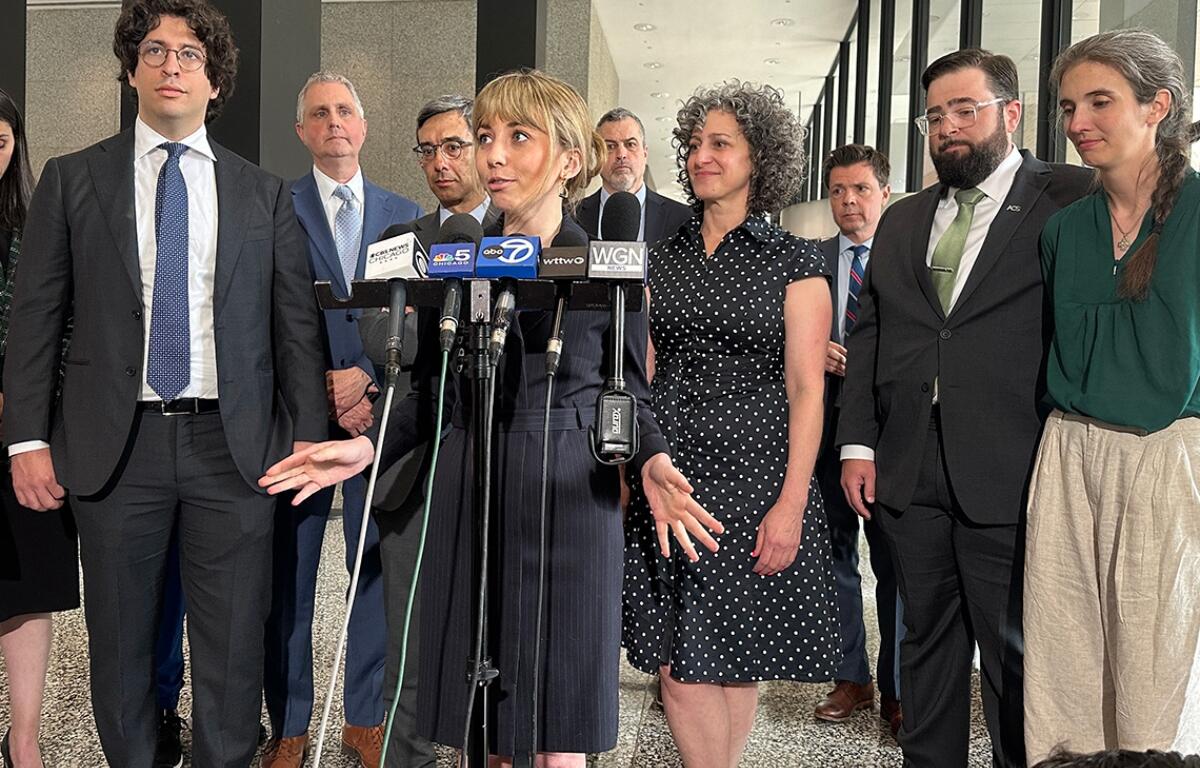 Social media influencer and former congressional candidate Katherine “Kat” Abughazaleh, center, addresses the media Thursday following the dismissal of charges. (Capitol News Illinois photo by Hannah Meisel)