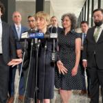 Social media influencer and former congressional candidate Katherine “Kat” Abughazaleh, center, addresses the media Thursday following the dismissal of charges. (Capitol News Illinois photo by Hannah Meisel)