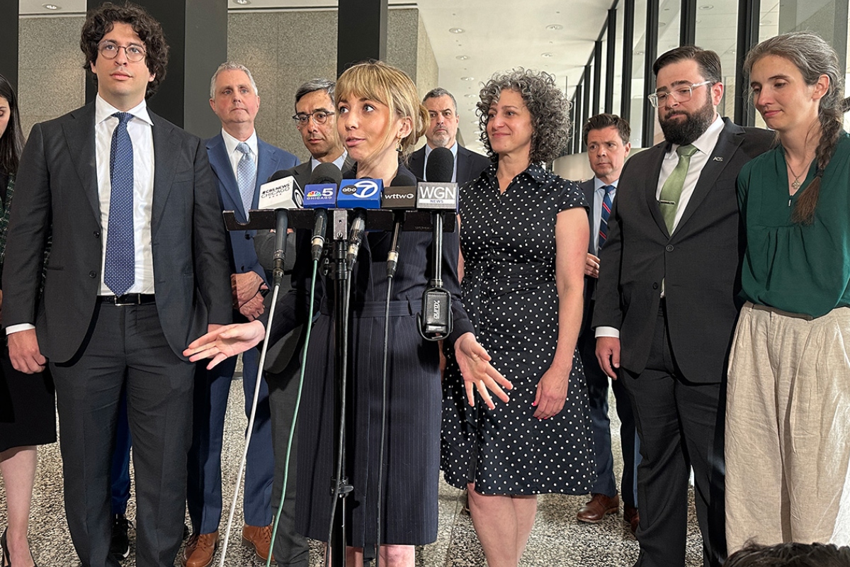 Social media influencer and former congressional candidate Katherine “Kat” Abughazaleh, center, addresses the media Thursday following the dismissal of charges. (Capitol News Illinois photo by Hannah Meisel)