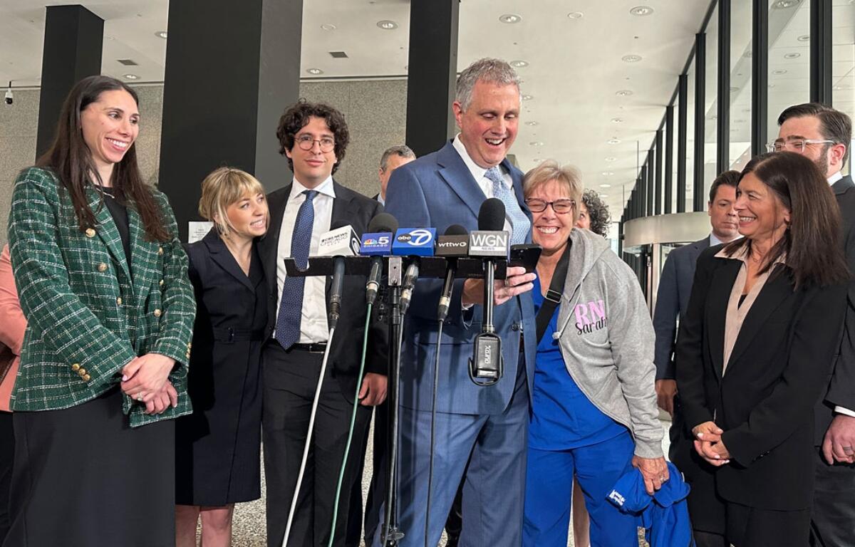 Chicago’s 45th Ward Committeeman Michael Rabbitt and his wife Sarah celebrate the remaining charges being dropped against him and his co-defendants, also pictured, in the “Broadview Six” protest case. (Capitol News Illinois photo by Hannah Meisel)