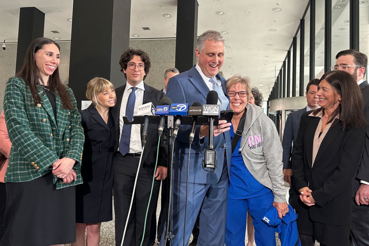 Chicago’s 45th Ward Committeeman Michael Rabbitt and his wife Sarah celebrate the remaining charges being dropped against him and his co-defendants, also pictured, in the “Broadview Six” protest case. (Capitol News Illinois photo by Hannah Meisel)