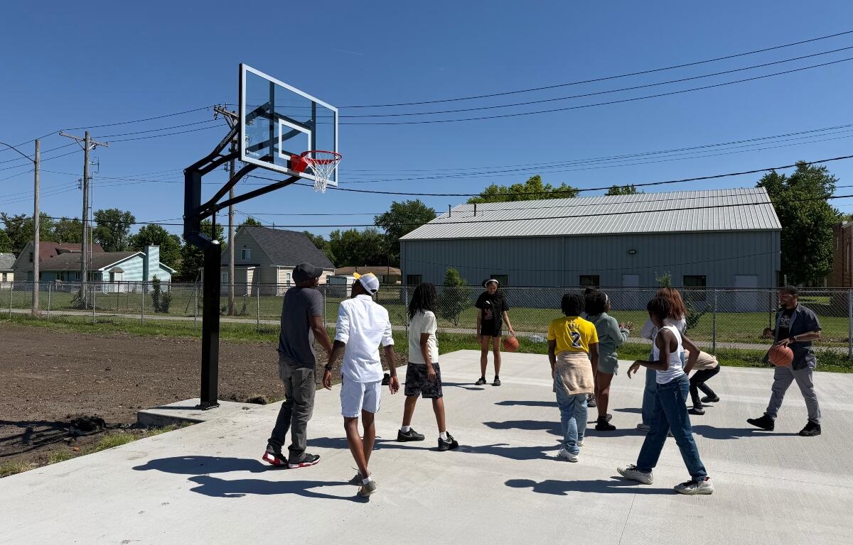 Kids and others play basketball on a court newly installed at the Boys and Girls Club location at 15th and Monroe.