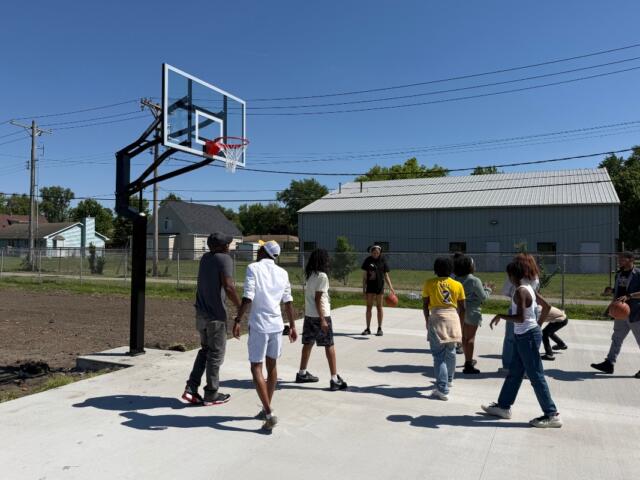 Kids and others play basketball on a court newly installed at the Boys and Girls Club location at 15th and Monroe.