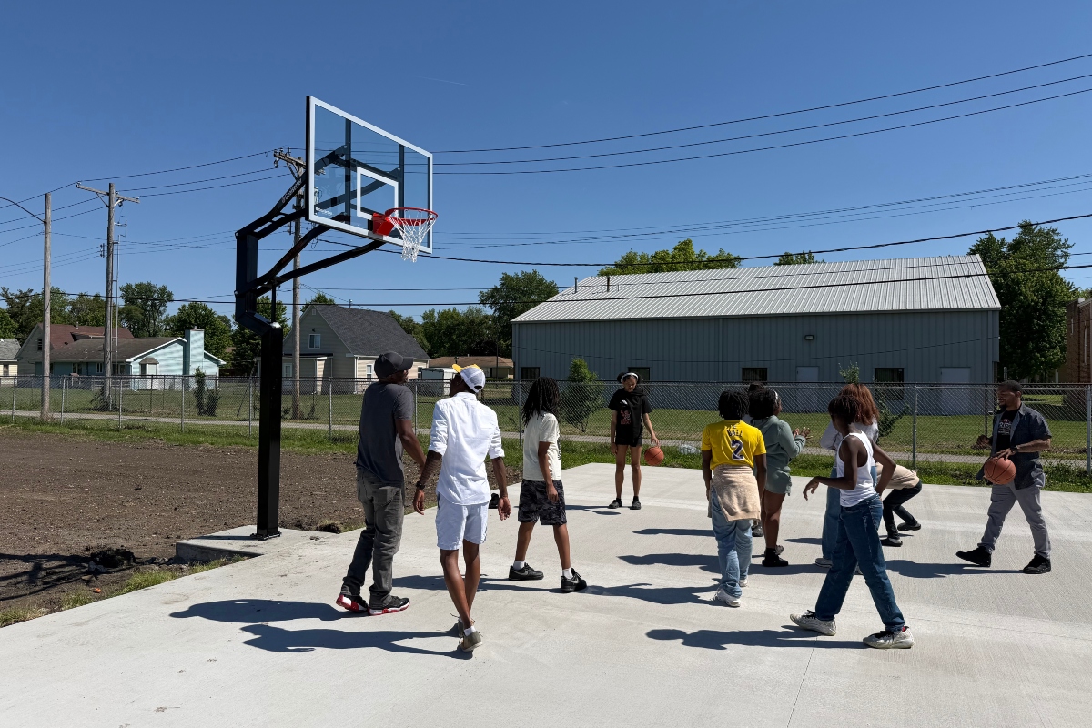 Kids and others play basketball on a court newly installed at the Boys and Girls Club location at 15th and Monroe.