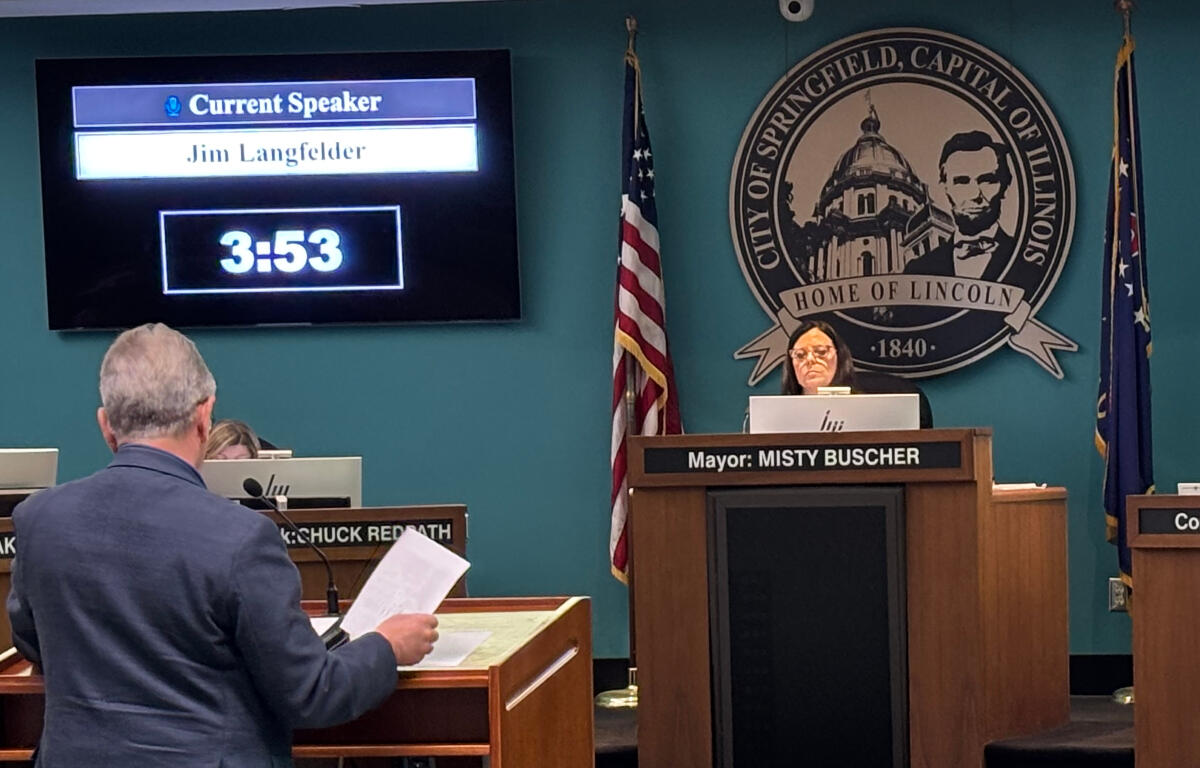 City council chamber: screen shows 'Current Speaker Jim Langfelder' at 3:53 as Mayor Misty Buscher speaks from the central podium with the Springfield, Illinois seal behind her.