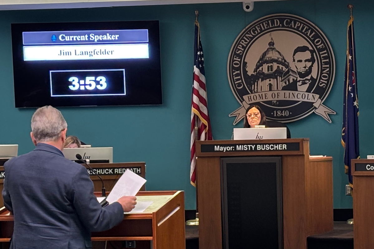 City council chamber: screen shows 'Current Speaker Jim Langfelder' at 3:53 as Mayor Misty Buscher speaks from the central podium with the Springfield, Illinois seal behind her.
