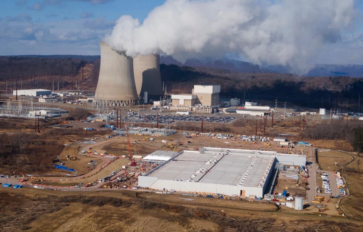 FILE - A data center owned by Amazon Web Services, front right, is under construction next to the Susquehanna nuclear power plant in Berwick, Pa., Jan. 14, 2025. (AP Photo/Ted Shaffrey, File)