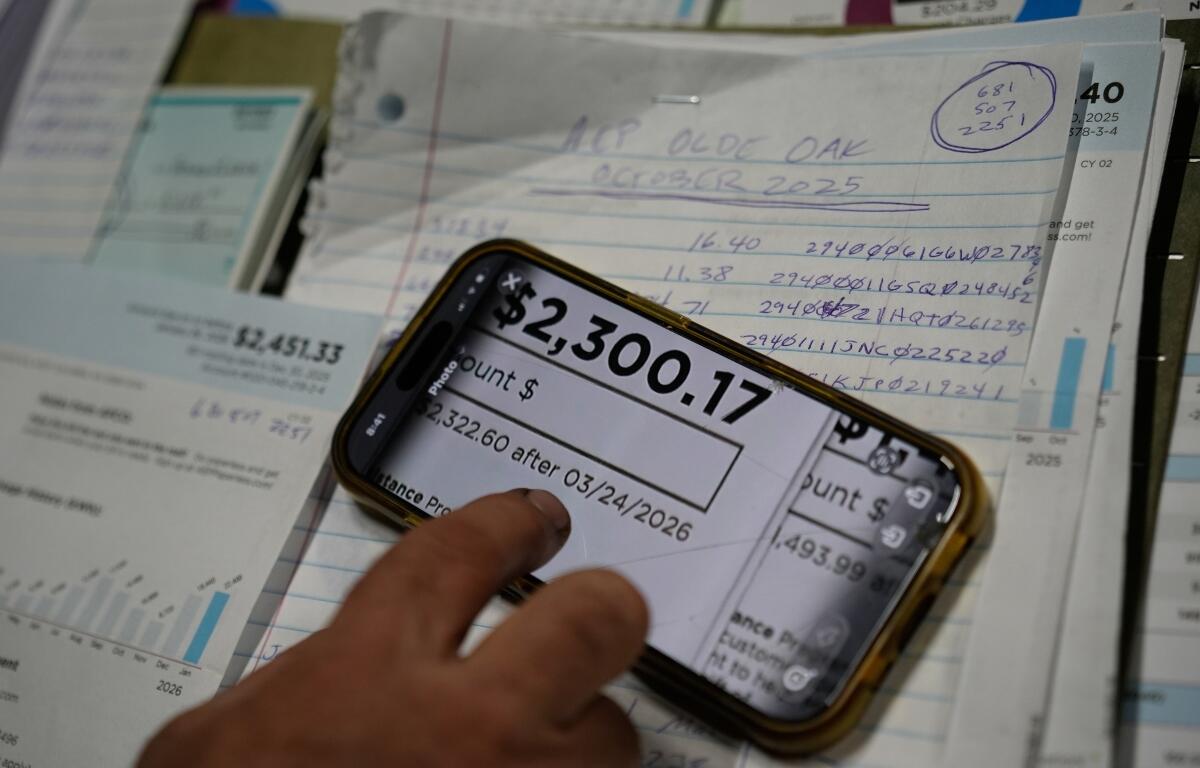 FILE - Eric Pinson, manager and resident of the Lock 24 RV Park and Campground, one of two such locations he manages in the area, looks over the business' electric bills, at his home at the campground in Racine, Ohio, March 13, 2026. (AP Photo/Carolyn Kaster, File)