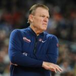 FILE - Illinois head coach Brad Underwood watches froom the sidelines during the first half of an NCAA college basketball tournament semifinal game against UConn at the Final Four, April 4, 2026, in Indianapolis. (AP Photo/Michael Conroy, File)
