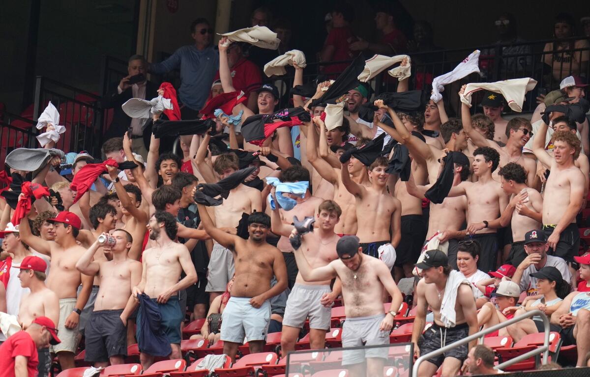 Fans cheer and wave their shirts above their heads during the fourth inning of a baseball game between the St. Louis Cardinals and the Kansas City Royals Saturday, May 16, 2026, in St. Louis. (AP Photo/Jeff Roberson)