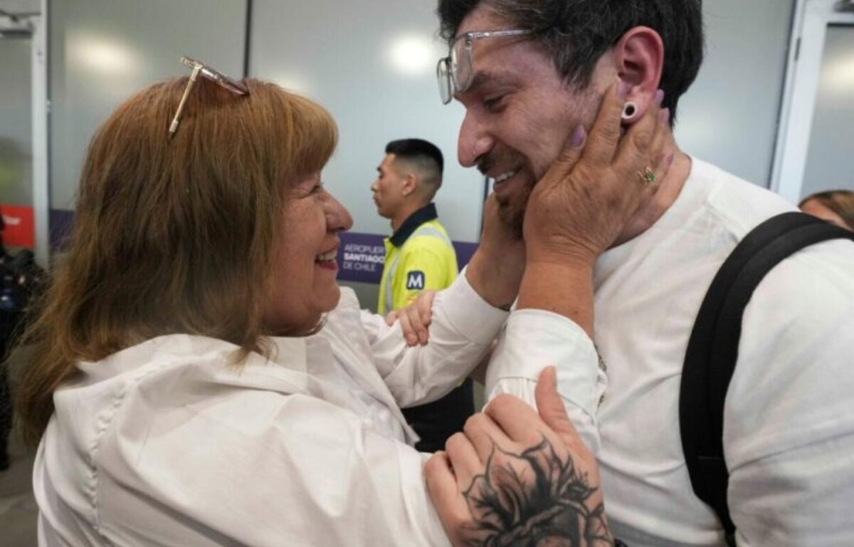 Kyle Adler, a 36-year-old Chilean American who was taken from his family at nine months old and illegally adopted, embraces his birth mother, Ana Maria Navarrete, after traveling from the U.S. to meet her for the first time, in Santiago, Chile, Saturday, Feb. 14, 2026. (AP Photo/Esteban Felix)