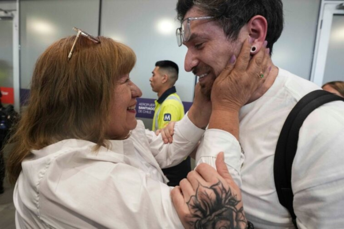 Kyle Adler, a 36-year-old Chilean American who was taken from his family at nine months old and illegally adopted, embraces his birth mother, Ana Maria Navarrete, after traveling from the U.S. to meet her for the first time, in Santiago, Chile, Saturday, Feb. 14, 2026. (AP Photo/Esteban Felix)