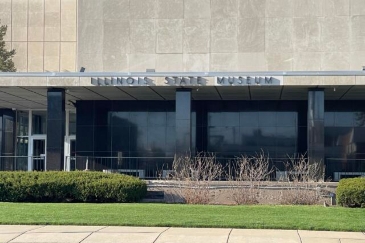 Illinois State Museum building facade with glass entrance and manicured lawn in front