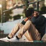 Student, mental health and depression with anxiety, burnout and sad for exam results, fail or mistake while sitting outdoor. Young man, stress and tired and depressed on university or college campus