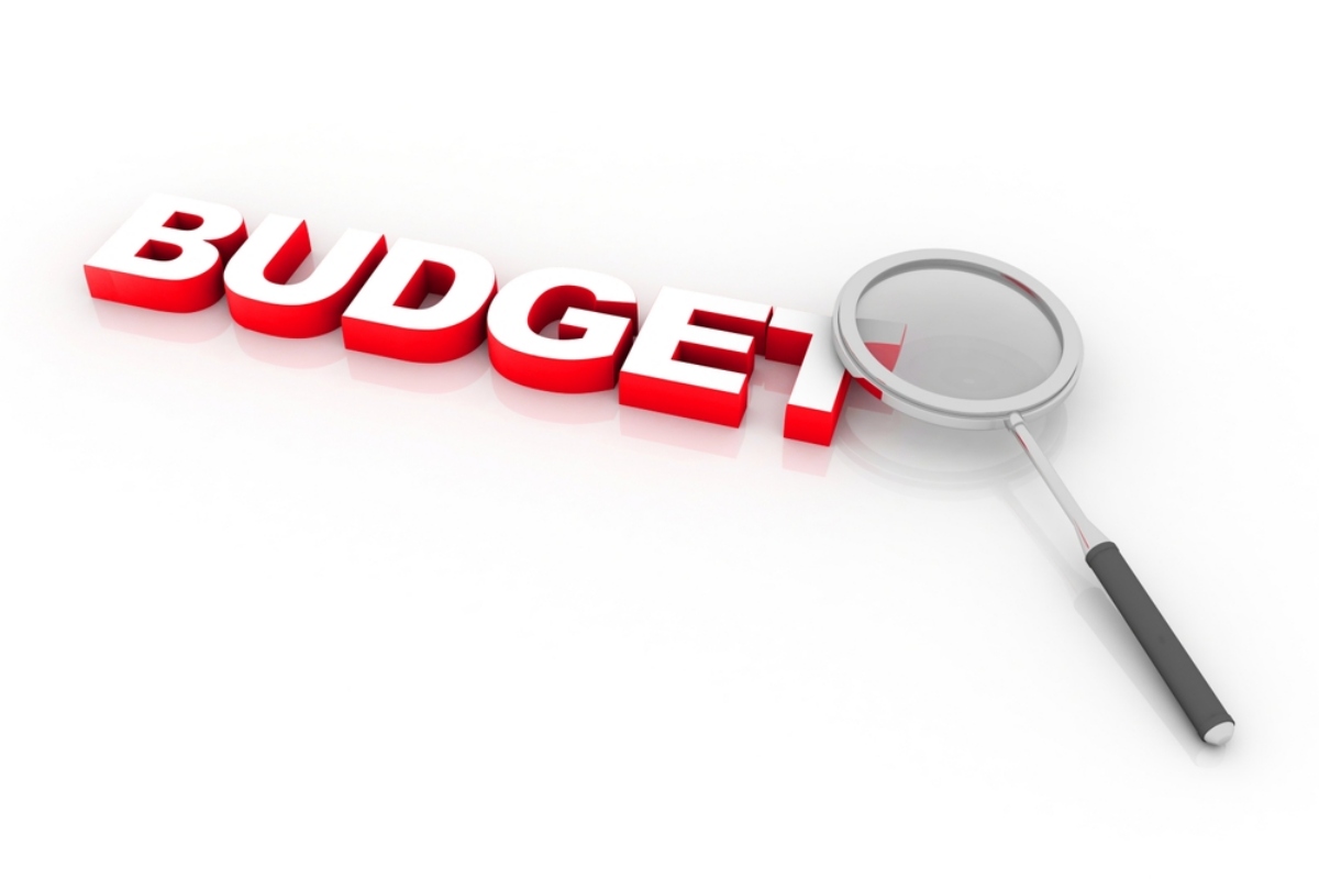 Red 3D word 'BUDGET' with a magnifying glass, implying budget review or analysis