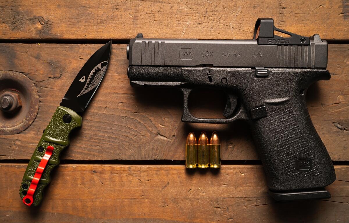 The most popular pistol for self-defense Glock 43x mos with a red dot sight and a tactical folding knife.