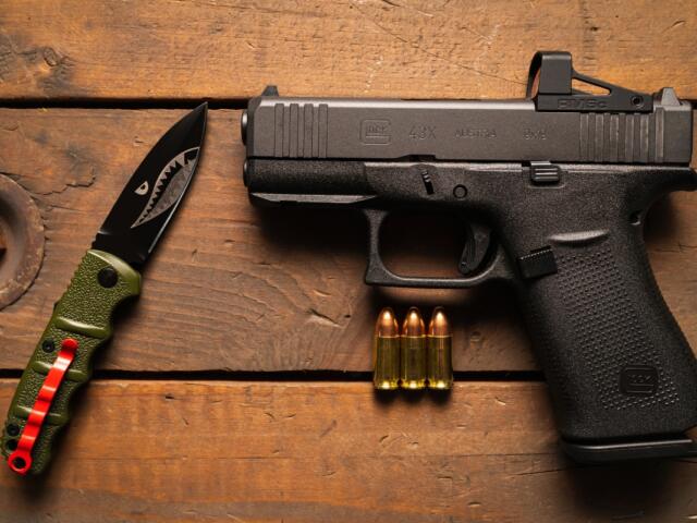 The most popular pistol for self-defense Glock 43x mos with a red dot sight and a tactical folding knife.