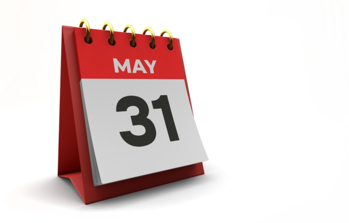 Desk calendar open to May 31 with a red base and gold rings
