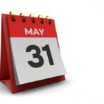 Desk calendar open to May 31 with a red base and gold rings
