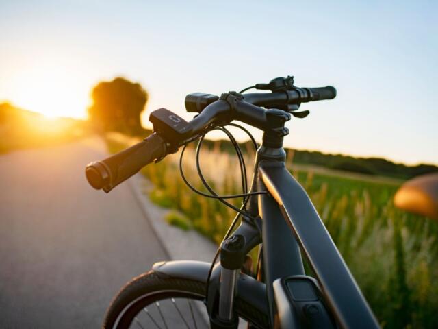 E-bike on the country road at sunset