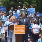 Robyn Gabel, D-Evanston, and Sen. Ram Villivalam, D-Chicago, speak at a rally for the POWER Act, a bill regulating data centers, about the bill’s next steps after the session ends. (Capitol News Illinois photo by Peter Hancock)