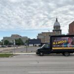 A “Credit Card Chaos” ad appears on a drivable billboard a few blocks from the Illinois Capitol during the legislature’s final stretch. The Illinois law that it targets suffered a pair of setbacks this week. (Capitol News Illinois photo by Jerry Nowicki)