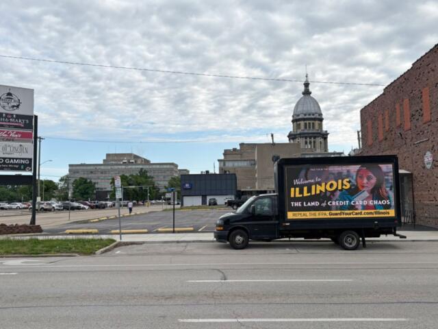 A “Credit Card Chaos” ad appears on a drivable billboard a few blocks from the Illinois Capitol during the legislature’s final stretch. The Illinois law that it targets suffered a pair of setbacks this week. (Capitol News Illinois photo by Jerry Nowicki)