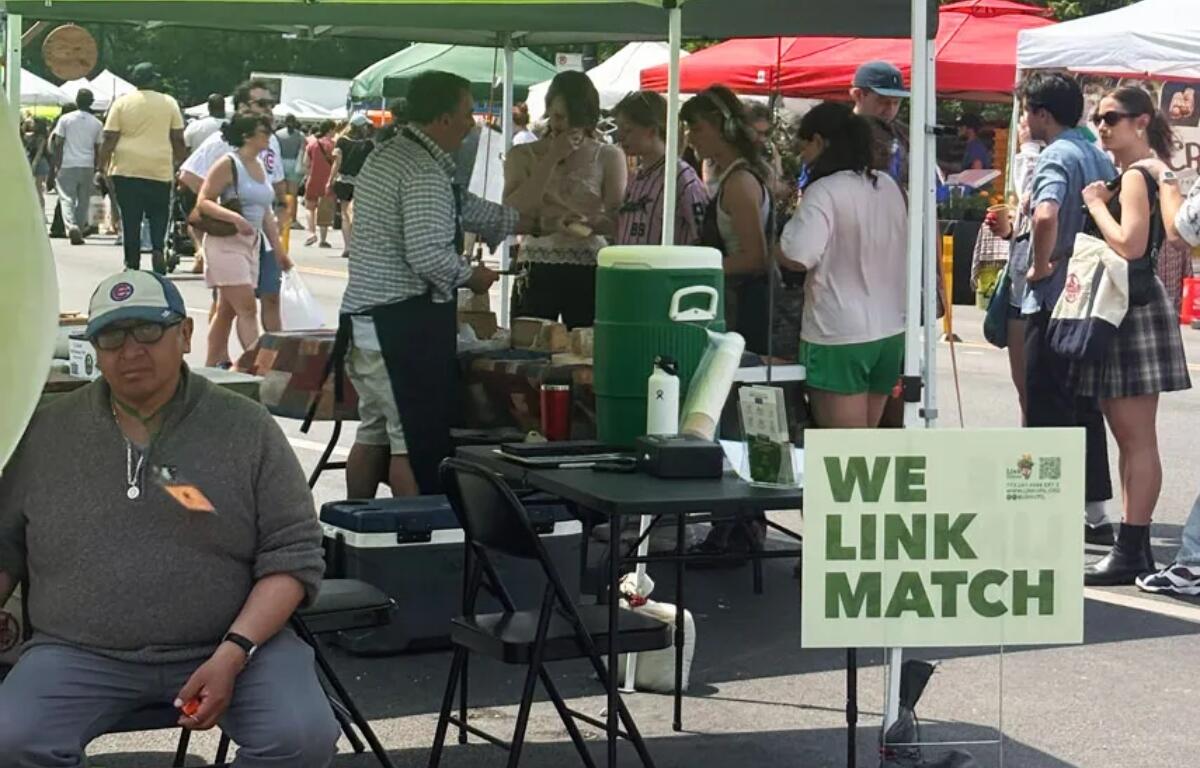 A scene at the station where SNAP users can swipe their EBT card for Link Match vouchers at the Logan Square Farmers Market in Chicago (Medill Illinois News Bureau photo by Molly A. Wallace)