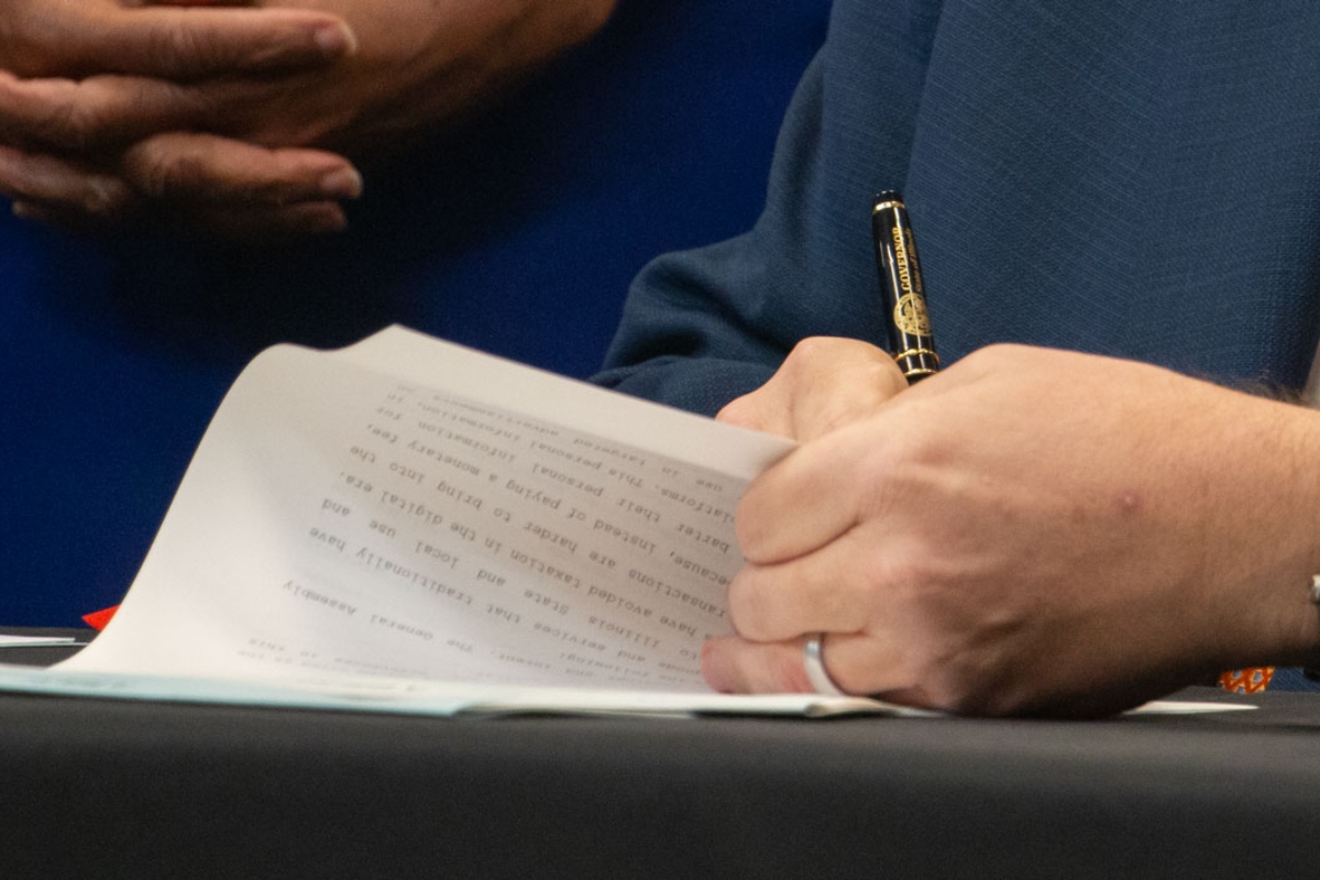 Gov. JB Pritzker signs a bill into law. (Capitol News Illinois photo by Maggie Dougherty)