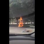 This grab from a video taken by motorist Keinika Carlton shows a wooden cross engulfed in bright orange flames as it leans against a tree in Grant Park, Chicago, Illinois, on Tuesday, July 9, 2026.(Keinika Carlton via AP)