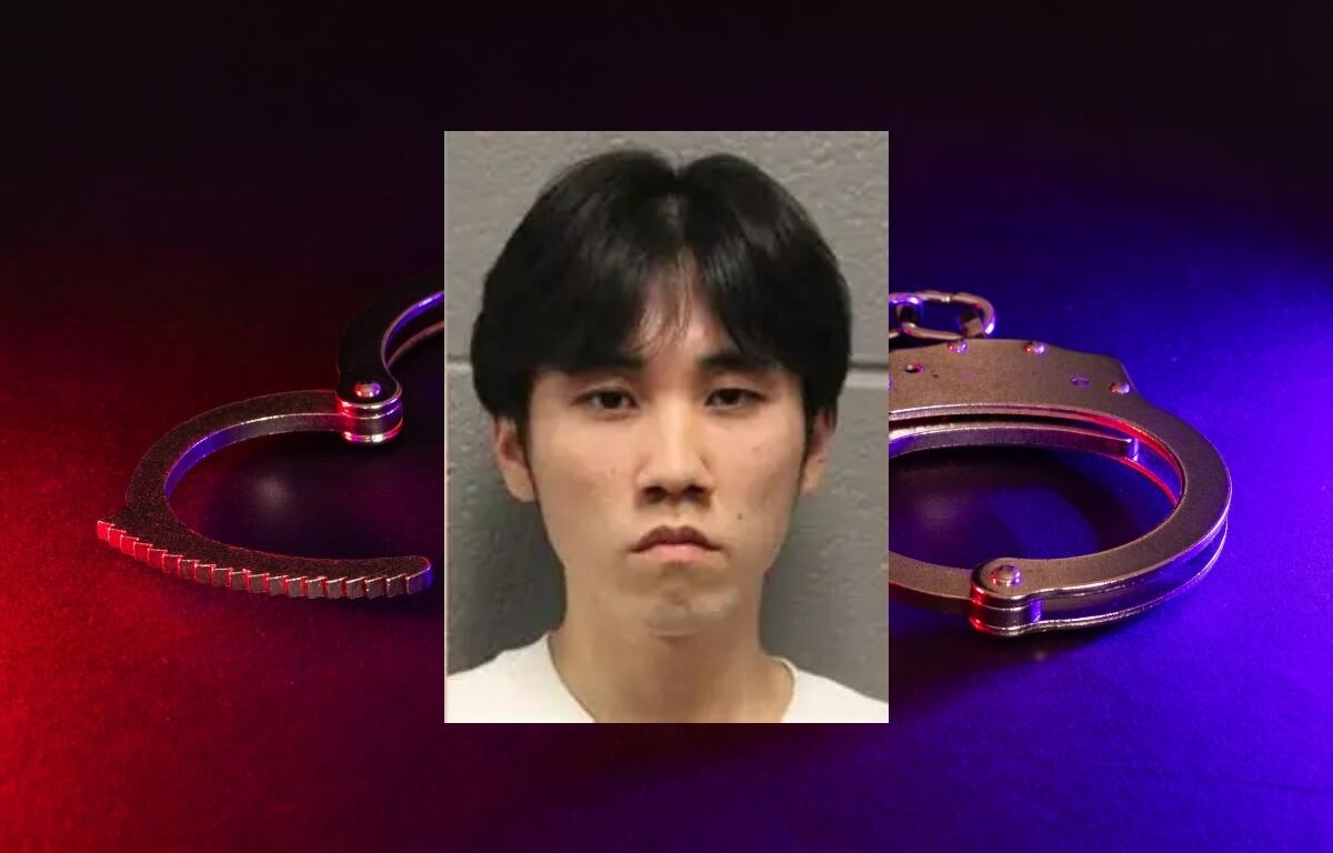 Merlin Lu has been charged with a hate crime after Chicago Police claim he set a cross on fire in the city's Grant Park.
