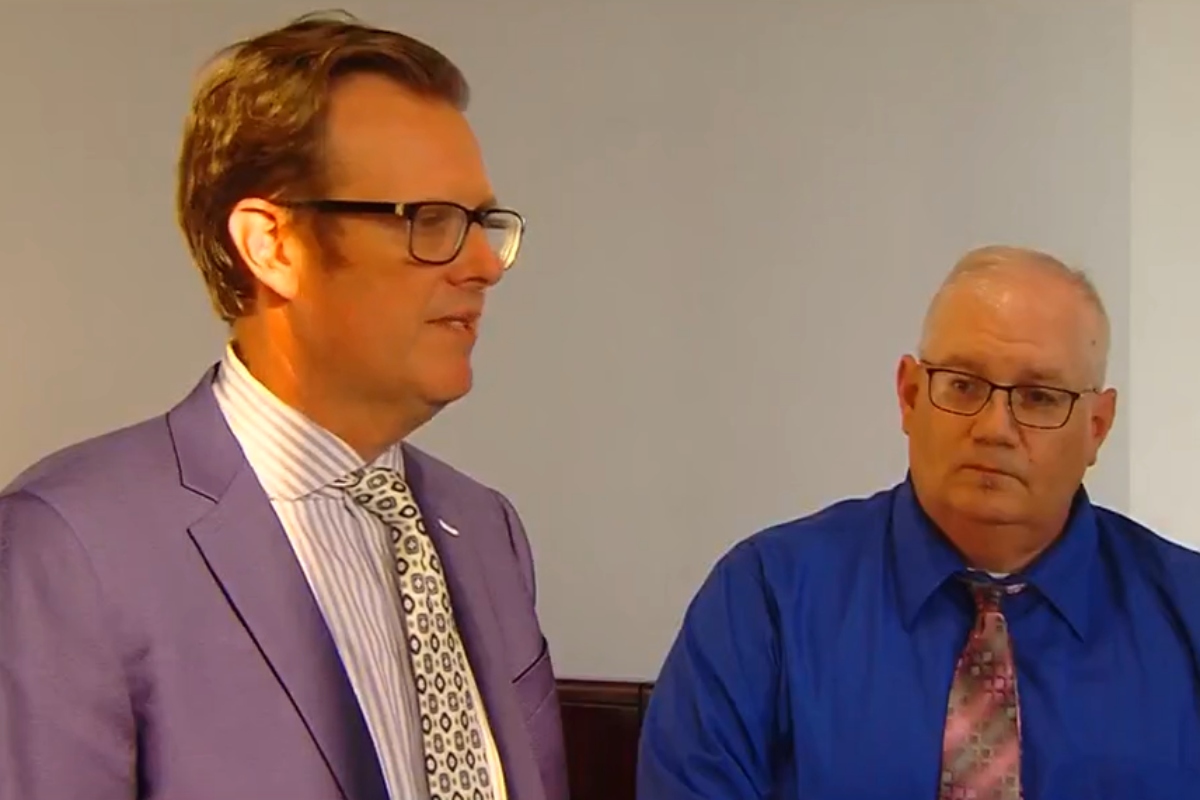 Peter Cadigan, right, listens as attorney Justin Kuehn speaks to reporters following Cadigan's sentencing.