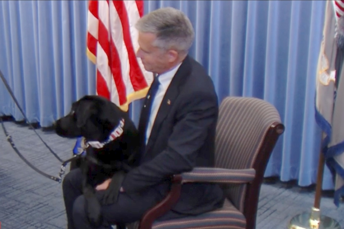 U.S. Attorney Gregory Gilmore holds Maisy, his office's new therapy dog.