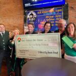 The St. Patrick's Day parade in Springfield gives a check for $10,000 in proceeds to the Downtown Springfield Heritage Foundation, who is in turn giving the money to the new "My Heart's Downtown" initiative.
