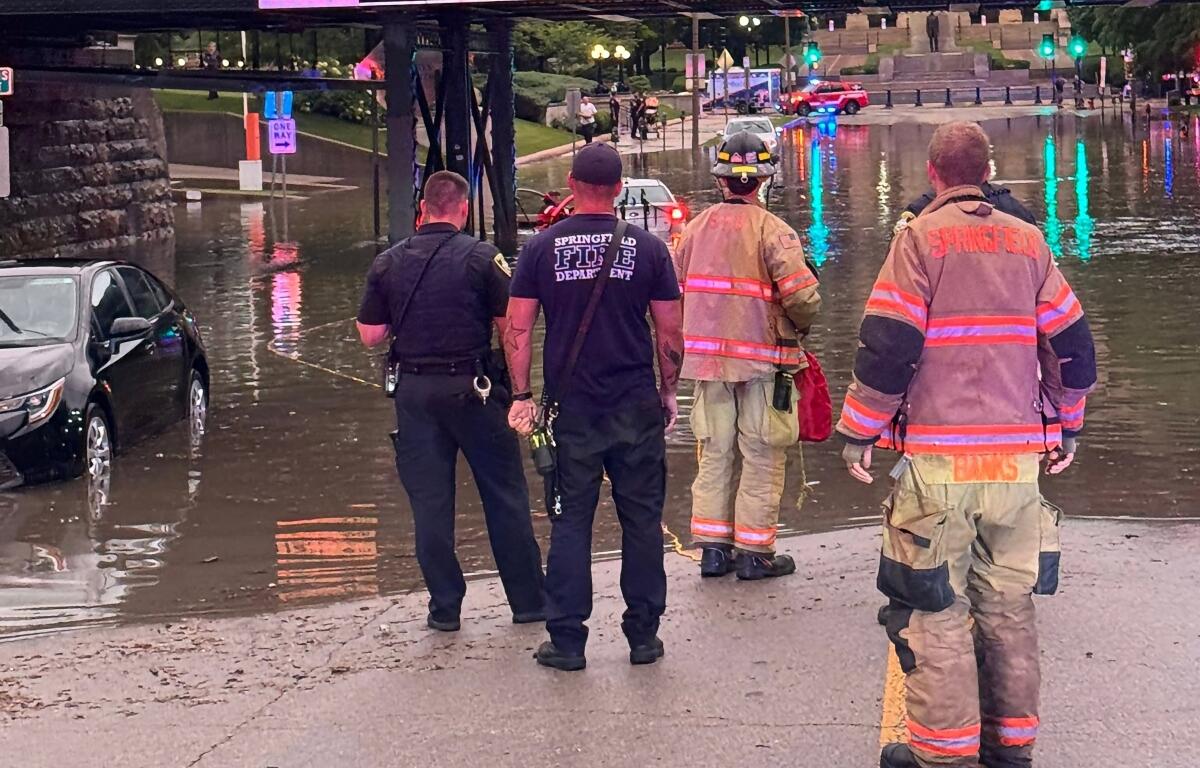 Springfield Firefighters rescue a submerged vehicle Monday, June 8, near Third and Capitol Streets.