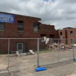 Fencing surrounds what's left of Illinois State Fairgrounds Building 29, which is in the process of being demolished.