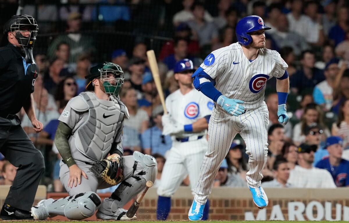 Chicago Cubs' Ian Happ, right, runs after hitting a one-run double during the ninth inning of a baseball game against the Athletics in Chicago, Thursday, June 4, 2026. (AP Photo/Nam Y. Huh)