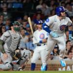 Chicago Cubs' Ian Happ, right, runs after hitting a one-run double during the ninth inning of a baseball game against the Athletics in Chicago, Thursday, June 4, 2026. (AP Photo/Nam Y. Huh)