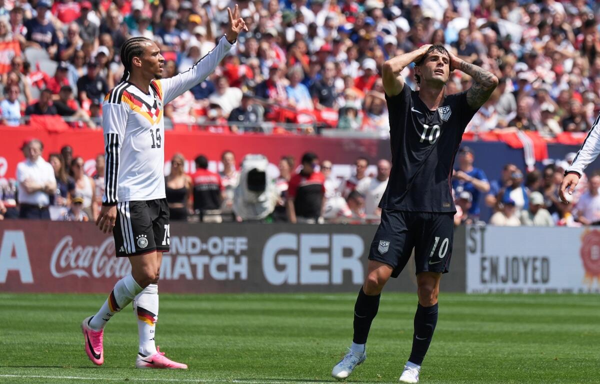 United States forward Christian Pulisic, right, reacts after a missed a shot as Germany forward Leroy Sané celebrates during the first half of an international friendly soccer match in Chicago, Saturday, June 6, 2026. (AP Photo/Nam Y. Huh)
