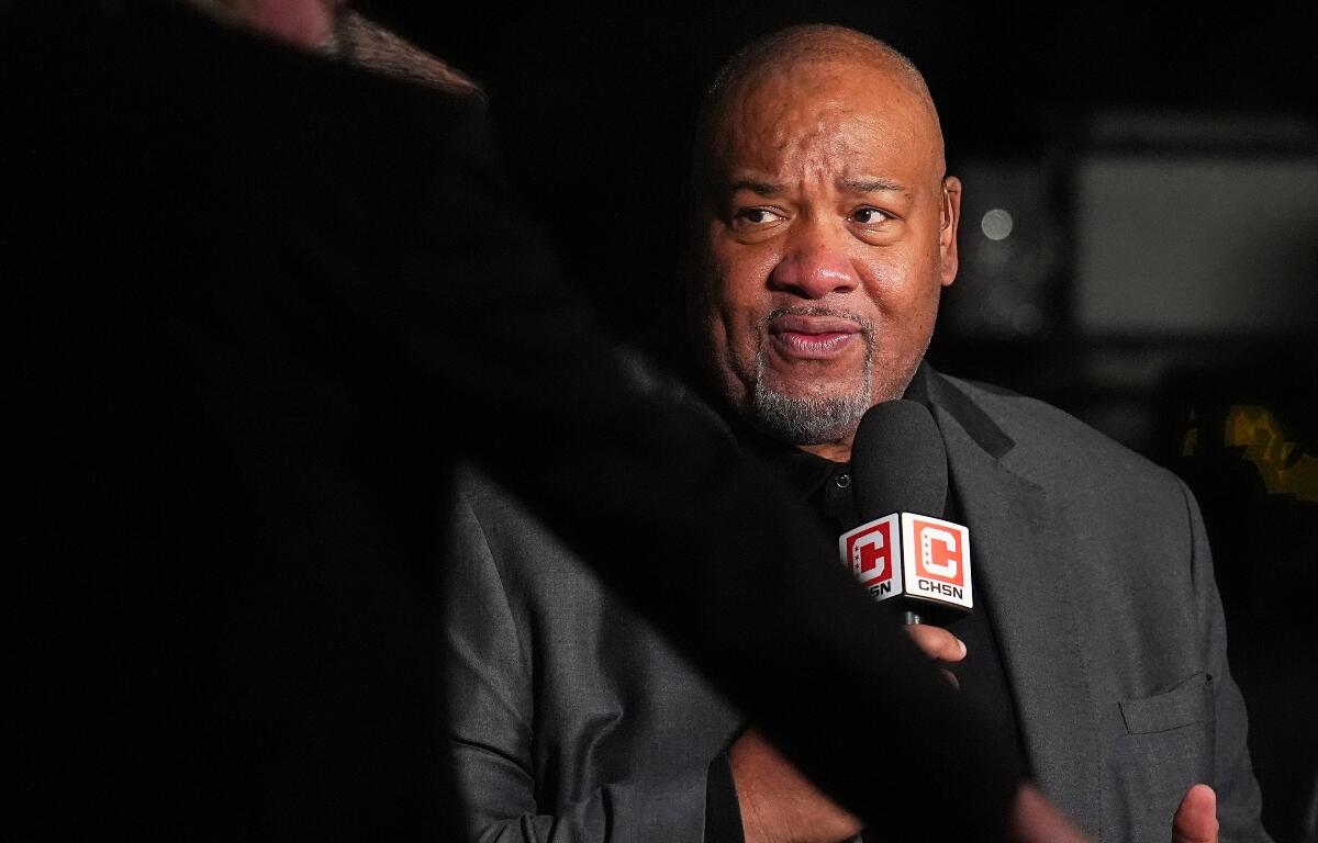 Man in a gray suit being interviewed at night, speaking into a CHSN microphone.
