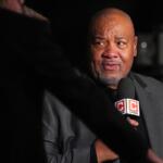 Man in a gray suit being interviewed at night, speaking into a CHSN microphone.