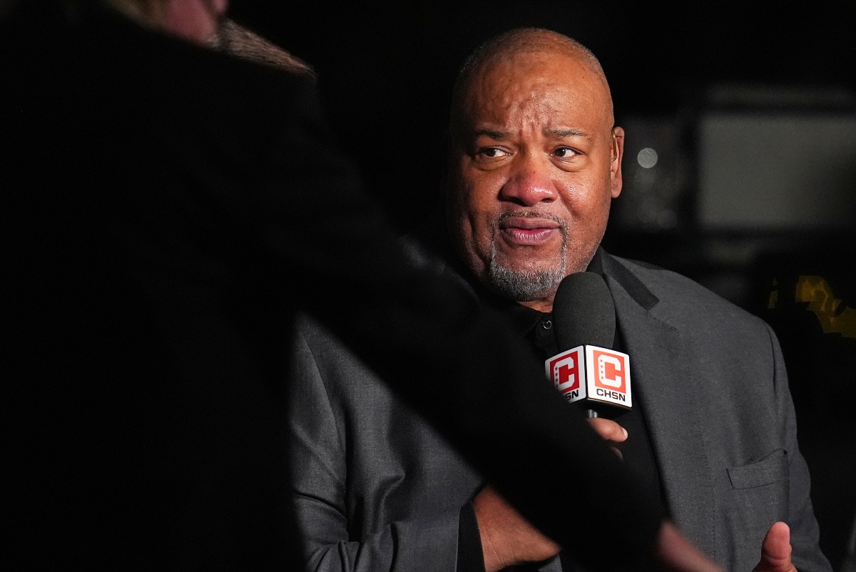 Man in a gray suit being interviewed at night, speaking into a CHSN microphone.