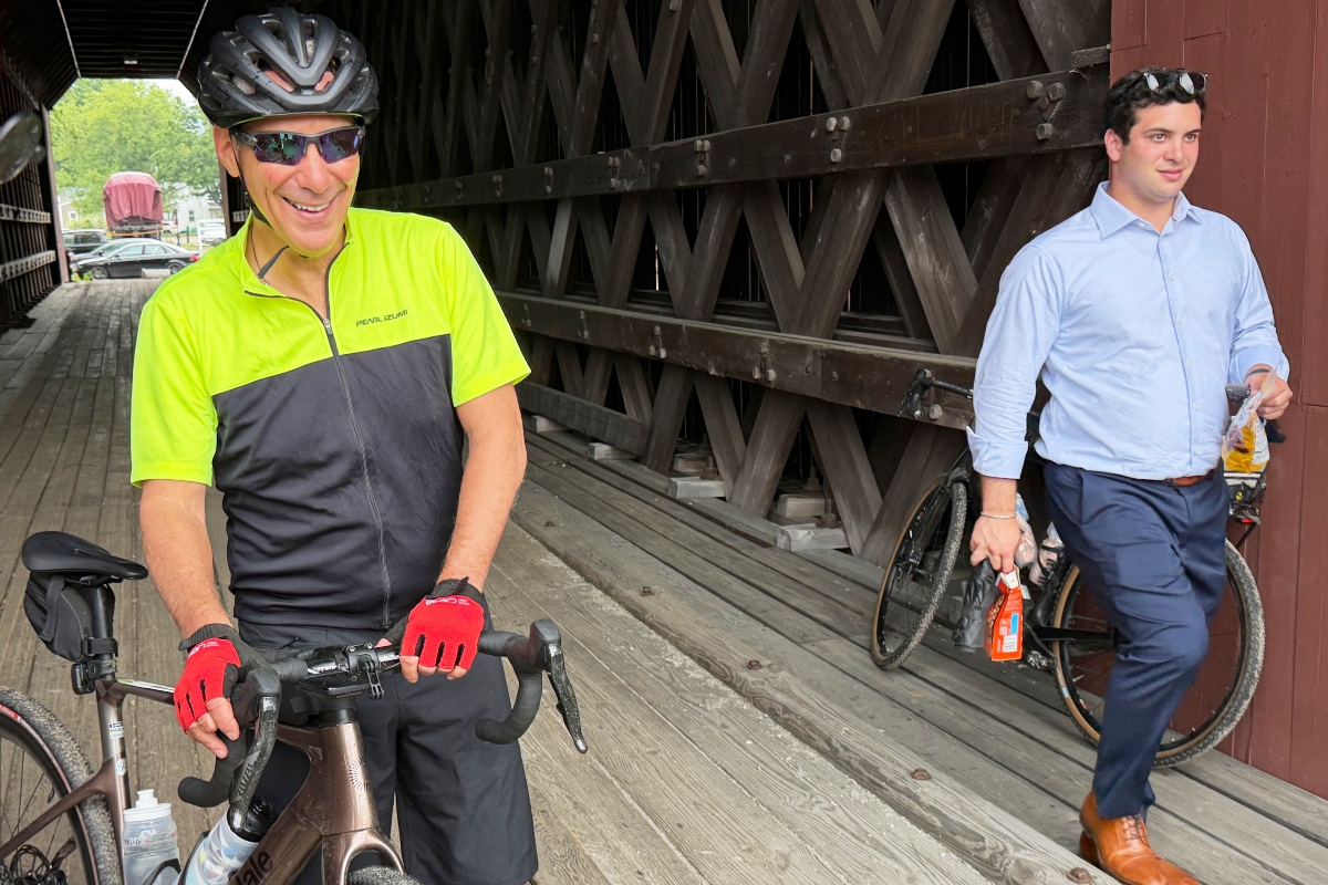Rahm Emanuel takes a break from a bike ride through New Hampshire, Saturday, June 6, 2026. (AP Photo/Steven Sloan)