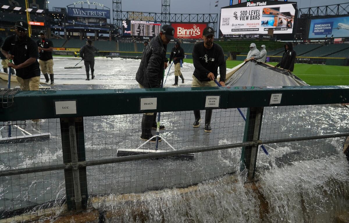 Grounds crew remove water from the field after severe thunderstorms came through the Chicago area before a baseball game between the Chicago White Sox and the Atlanta Braves, Wednesday, June 10, 2026, in Chicago. (AP Photo/David Banks)