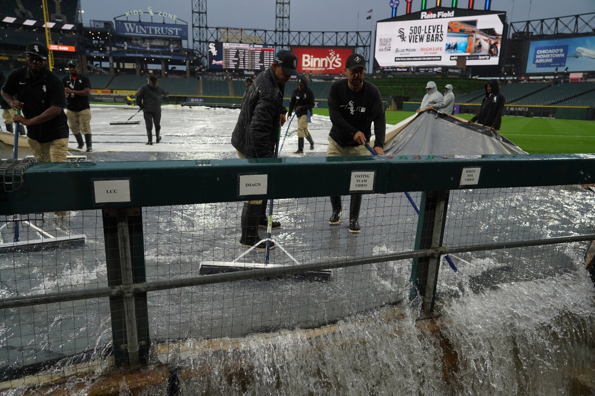 Grounds crew remove water from the field after severe thunderstorms came through the Chicago area before a baseball game between the Chicago White Sox and the Atlanta Braves, Wednesday, June 10, 2026, in Chicago. (AP Photo/David Banks)