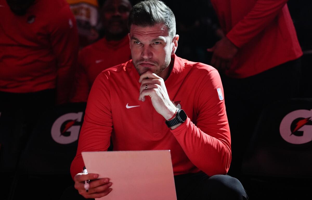 FILE - Portland Trail Blazers interim head coach Tiago Splitter listens during introductions before an NBA basketball game against the Brooklyn Nets, March 23, 2026, in Portland, Ore. (AP Photo/Jenny Kane, File)